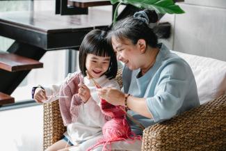 Grandmother and granddaughter knitting together